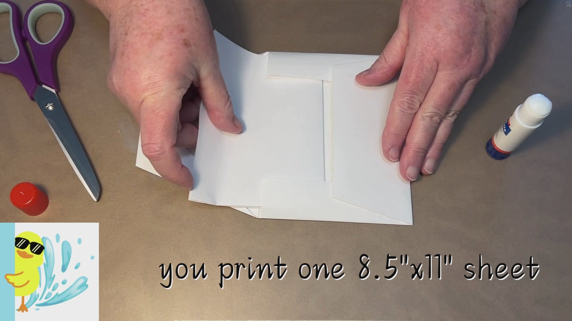 Load video: worktable with glue and scissors, showing insertion of a Duck Soup Designs card into a custom Duck Soup Designs envelope